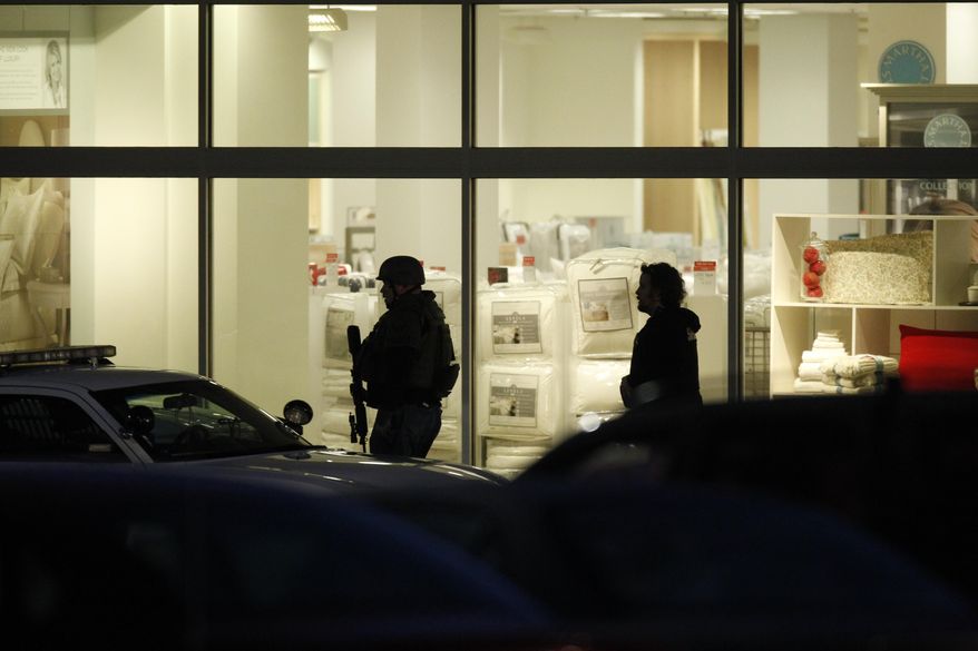 Law enforcement personnel work the scene of a shooting at the Clackamas Town Center in Portland, Ore. Tuesday, Dec. 11, 2012. A gunman is dead after opening fire in the Portland, Ore., area shopping mall Tuesday, killing two people and wounding another, sheriff's deputies said. (AP Photo/The Oregonian, Bruce Ely)