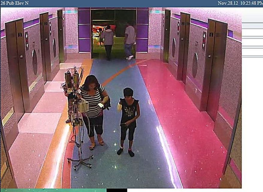 In this hospital surveillance photo released by the Phoenix Police Department on Dec. 3, 2012, a woman is seen with her 11-year-old daughter, a leukemia patient who had her arm amputated and a heart catheter inserted due to an infection. Authorities say the woman inexplicably took the girl from the hospital last week. Police say that if the catheter is left in too long it could lead to a deadly infection. The family’s identity is being withheld but they are calling the girl Emily. (Associated Press/Phoenix Police Department)