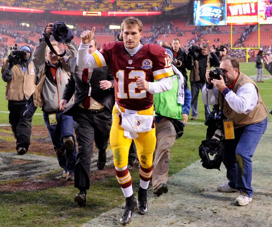 preston keres/special to the washington times
Redskins backup quarterback Kirk Cousins was the man of the hour after sparking Washington’s 312-28 victory over Baltimore by tossing a touchdown pass with 29 seconds left, then scoring the two-point conversion (below) before a field goal won it in overtime. Cousins entered the game after Robert Griffin III suffered a knee injury.