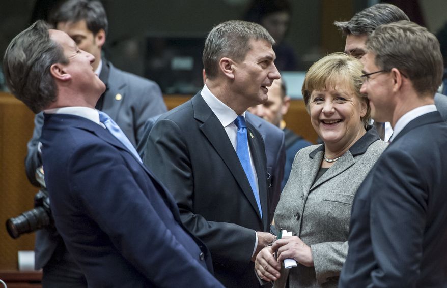 British Prime Minister David Cameron (left) laughs as he speaks with (from right) Finland&#x27;s Prime Minister Jyrki Tapani Katainen, Croatian Prime Minister Zoran Milanovic, German Chancellor Angela Merkel and Estonia&#x27;s Prime Minister Andrus Ansip during a round table meeting at an EU summit in Brussels on Dec. 13, 2012. (Associated Press)