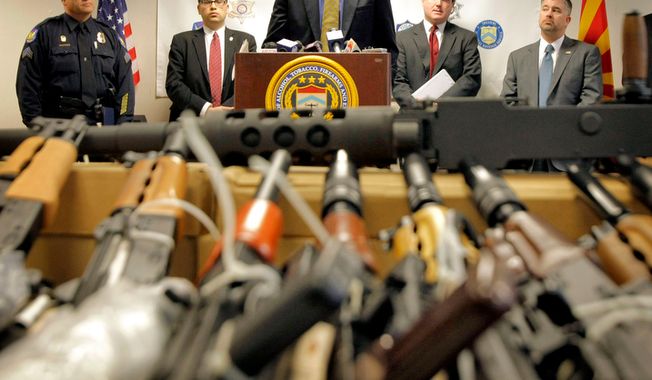 Bill Newell, special agent in charge of ATF Phoenix, speaks Jan. 25, 2011, behind a cache of seized weapons in Phoenix. The ATF is under fire over a Phoenix-based gun-trafficking investigation called &quot;Fast and Furious,&quot; in which agents allowed hundreds of guns into the hands of straw purchasers in hopes of making a bigger case. (Associated Press) **FILE**
