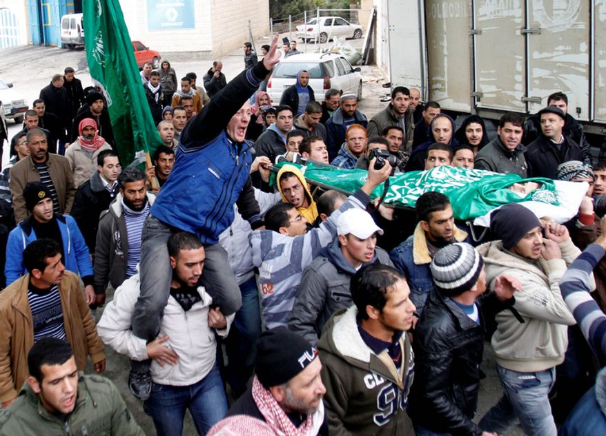 Palestinians carry the body of Mohammed Suleima, 17, during his funeral in the West Bank city of Hebron, Thursday, Dec. 13, 2012. (AP Photo/Nasser Shiyoukhi)