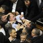 Ukrainian lawmakers fight around the rostrum during the first session of Ukraine&#39;s newly elected parliament in Kiev on Thursday, Dec. 13, 2012. (AP Photo/Sergei Chuzavkov)