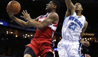 Washington Wizards shooting guard Bradley Beal (3) drives to the basket in front of New Orleans Hornets power forward Anthony Davis (23) in the first half of an NBA basketball game in New Orleans, Tuesday, Dec. 11, 2012. (AP Photo/Gerald Herbert)