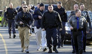 Law enforcement canvass the area following a shooting at the Sandy Hook Elementary School in Newtown, Conn., about 60 miles (96 kilometers) northeast of New York City, Friday, Dec. 14, 2012. An official with knowledge of Friday&#39;s shooting said 27 people were dead, including 18 children.  (AP Photo/Jessica Hill)
