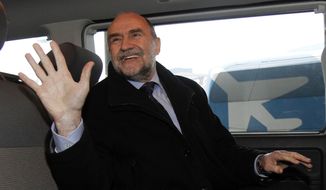 Herman Nackaerts, deputy director general and head of the Department of Safeguards of the International Atomic Energy Agency (IAEA), waves as he arrives from Iran at Schwechat Airport in Vienna, Austria, on Dec. 14, 2012. (Associated Press)