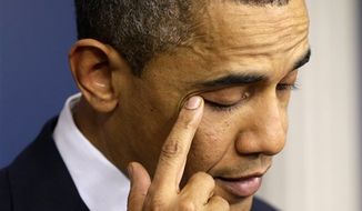 ** FILE ** President Barack Obama wipes his eye as he speaks about the school shooting in Newtown, Conn., Friday, Dec. 14, 2012, in the briefing room of the White House in Washington. (AP Photo/Charles Dharapak)
