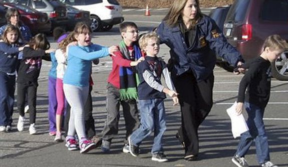In this photo provided by the Newtown Bee, Connecticut State Police lead children from the Sandy Hook Elementary School in Newtown, Conn., following a reported shooting there Friday, Dec. 14, 2012.  (AP Photo/Newtown Bee, Shannon Hicks)  