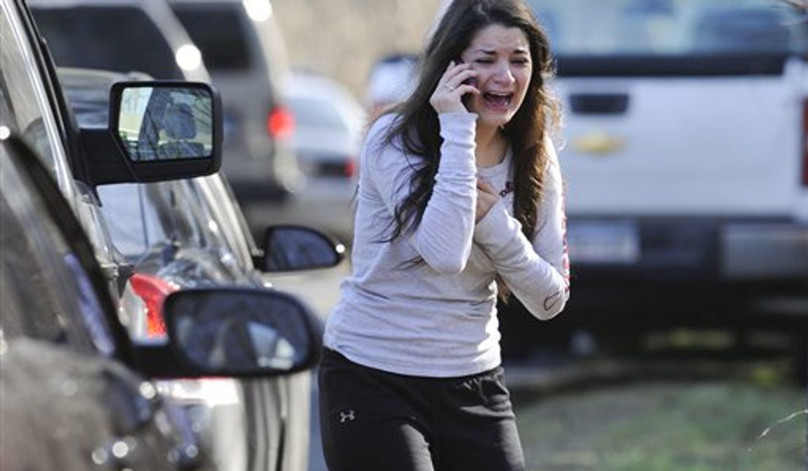 A woman waits to hear about her sister, a teacher, following a shooting at the Sandy Hook Elementary School in Newtown, Conn., about 60 miles (96 kilometers) northeast of New York City, Friday, Dec. 14, 2012. An official with knowledge of Friday&#x27;s shooting said 27 people were dead, including 18 children. It was the worst school shooting in the country&#x27;s history. (AP Photo/Jessica Hill)