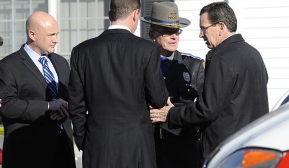 Gov. Dannel P. Malloy, right, talks with officials at a staging area following a shooting at the Sandy Hook Elementary School in Newtown, Conn., about 60 miles (96 kilometers) northeast of New York City, Friday, Dec. 14, 2012. An official with knowledge of Friday&#39;s shooting said 27 people were dead, including 18 children. (AP Photo/Jessica Hill)