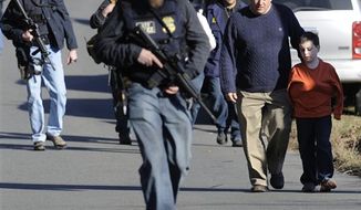 Parents leave a staging area after being reunited with their children following a shooting at the Sandy Hook Elementary School in Newtown, Conn., about 60 miles (96 kilometers) northeast of New York City, on Dec. 14, 2012. It was the worst school shooting in the country&#x27;s history. (Associated Press)