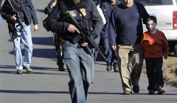 Parents leave a staging area after being reunited with their children following a shooting at the Sandy Hook Elementary School in Newtown, Conn., about 60 miles (96 kilometers) northeast of New York City, on Dec. 14, 2012. It was the worst school shooting in the country&#39;s history. (Associated Press)