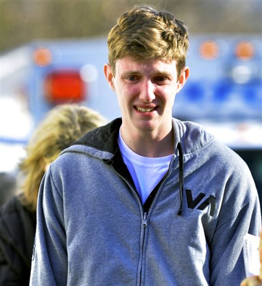 A man reacts following a shooting at the Sandy Hook Elementary School in Newtown, Conn., about 60 miles (96 kilometers) northeast of New York City, Friday, Dec. 14, 2012. An official with knowledge of Friday's shooting said 27 people were dead, including 18 children. It was the worst school shooting in the country's history. (AP Photo/The New Haven Register, Melanie Stengel)