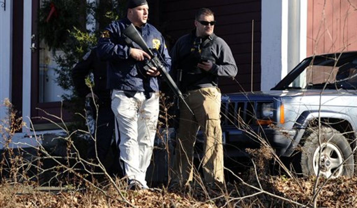 Law enforcement canvass an area following a shooting at the Sandy Hook Elementary School in Newtown, Conn., about 60 miles (96 kilometers) northeast of New York City, Friday, Dec. 14, 2012. An official with knowledge of Friday&#x27;s shooting said 27 people were dead, including 18 children.  (AP Photo/Jessica Hill)