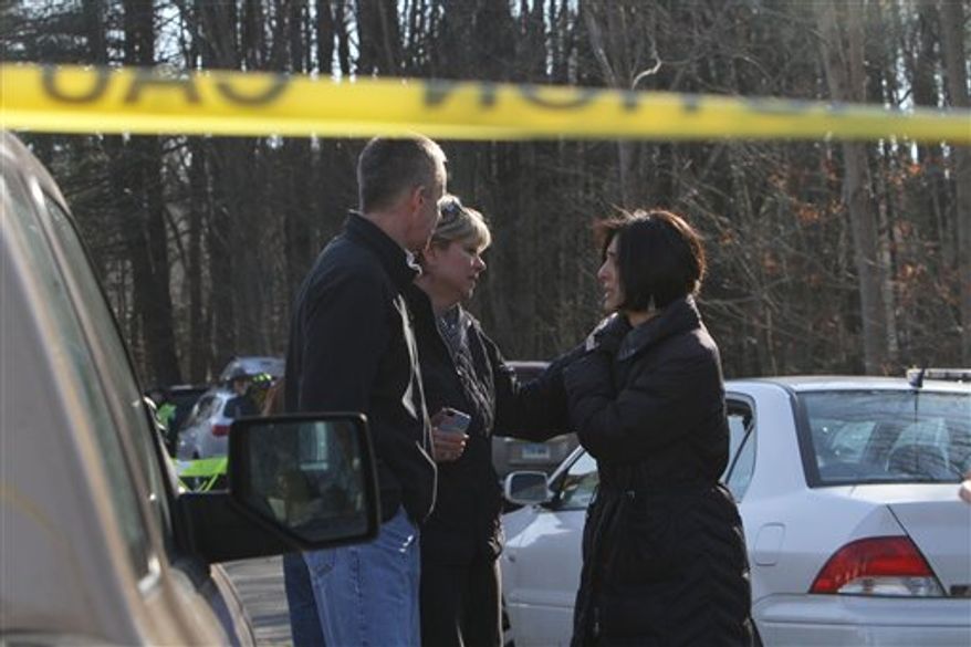 Teachers walk away from the Sandy Hook School following a shooting at the school Friday, Dec. 14, 2012 in Newtown, Conn. A man opened fire inside the Connecticut elementary school where his mother worked Friday, killing 26 people, including 18 children, and forcing students to cower in classrooms and then flee with the help of teachers and police. (AP Photo/The Journal News, Frank Becerra Jr.) MANDATORY CREDIT, NYC OUT, NO SALES, TV OUT, NEWSDAY OUT; MAGS OUT