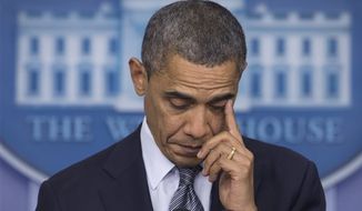 President Obama wipes his eye as he talks in the White House briefing room in Washington about the Connecticut elementary school shooting on Dec. 14, 2012. (Associated Press)