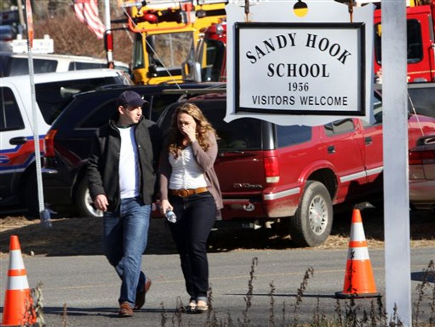 Parents walk away from the Sandy Hook Elementary School in Newtown, Conn., on Friday, Dec. 14, 2012, after a gunman killed 20 schoolchildren and 6 adults there. (AP Photo/The Journal News, Frank Becerra Jr.)