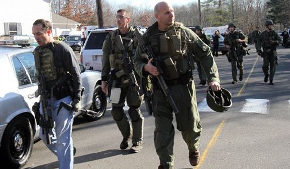 Heavily armed Connecticut State troopers are on the scene at the Sandy Hook School following a shooting at the school, Friday, Dec. 14, 2012 in Newtown, Conn. A man opened fire inside the Connecticut elementary school where his mother worked Friday, killing 26 people, including 18 children, and forcing students to cower in classrooms and then flee with the help of teachers and police. (AP Photo/The Journal News, Frank Becerra Jr.) MANDATORY CREDIT, NYC OUT, NO SALES, TV OUT, NEWSDAY OUT; MAGS OUT