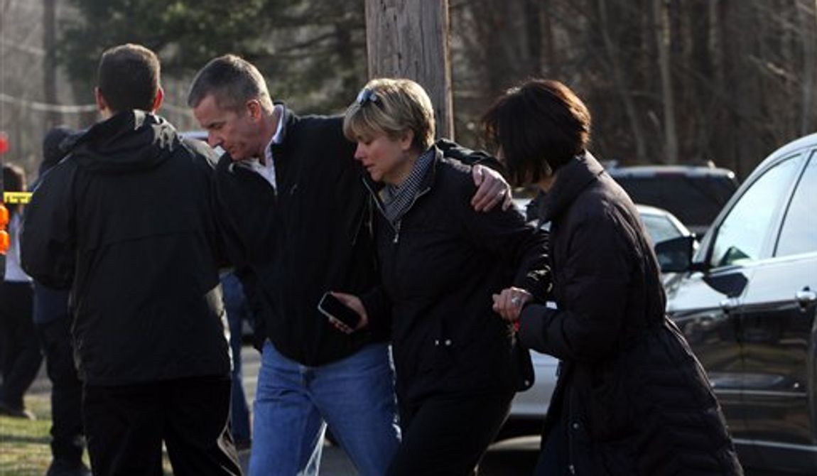 Teachers walk away from the Sandy Hook School following a shooting  at the school, Friday, Dec. 14, 2012 in Newtown, Conn. A man opened fire inside the Connecticut elementary school where his mother worked Friday, killing 26 people, including 18 children, and forcing students to cower in classrooms and then flee with the help of teachers and police. (AP Photo/The Journal News, Frank Becerra Jr.) MANDATORY CREDIT, NYC OUT, NO SALES, TV OUT, NEWSDAY OUT; MAGS OUT