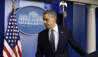 President Barack Obama leaves the podium after speaking about the school shooting in Newtown, Conn., Friday, Dec. 14, 2012, in the briefing room of the White House in Washington. (AP Photo/Charles Dharapak)