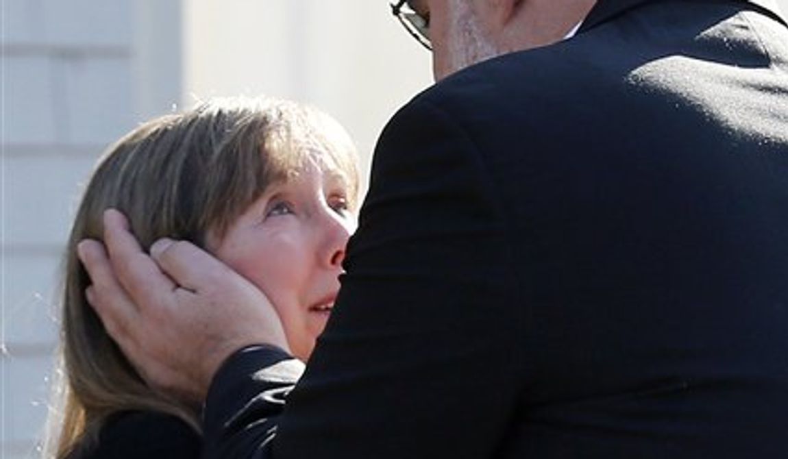 Two people embrace following a service at the Congregation Adath Israel in Newtown, Conn., Saturday, Dec. 15, 2012. Rabbi Shaul Praver said a six-year-old boy from the congregation was a school shooting victim and that he would be buried on Sunday. (AP Photo/Charles Krupa)