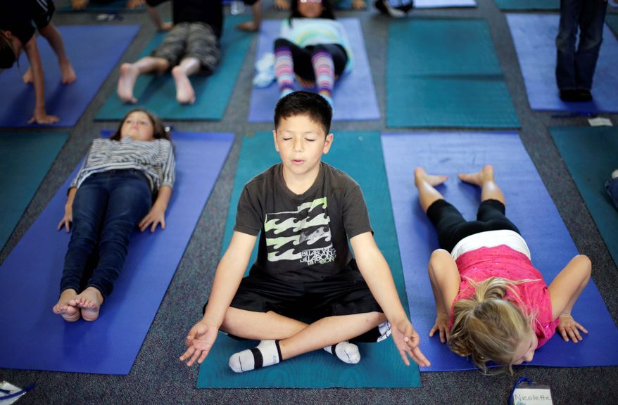 Fourth-grader Miguel Ruvalcaba holds a pose during a yoga class at Capri Elementary School in Encinitas, Calif. Officials of the school district are treading softly as they pioneer what may be the first district-wide yoga program of its kind, while also trying to avoid a legal dispute about religion. (Associated Press)