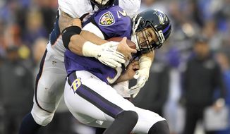 Baltimore Ravens quarterback Joe Flacco is sacked by Denver Broncos defensive end Derek Wolfe during the second half of an NFL football game in Baltimore, Sunday, Dec. 16, 2012. The Broncos defeated the Ravens 34-17. (AP Photo/Gail Burton)