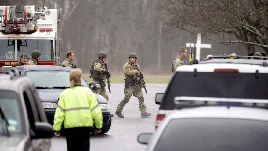A swat team responds to a bomb threat at St. Rose of Lima Roman Catholic Church, Sunday, Dec. 16, 2012, in Newtown, Conn. Worshippers hurriedly left the church Sunday, not far from where a gunman opened fire Friday inside the Sandy Hook Elementary School in Newtown. (AP Photo/David Goldman)
