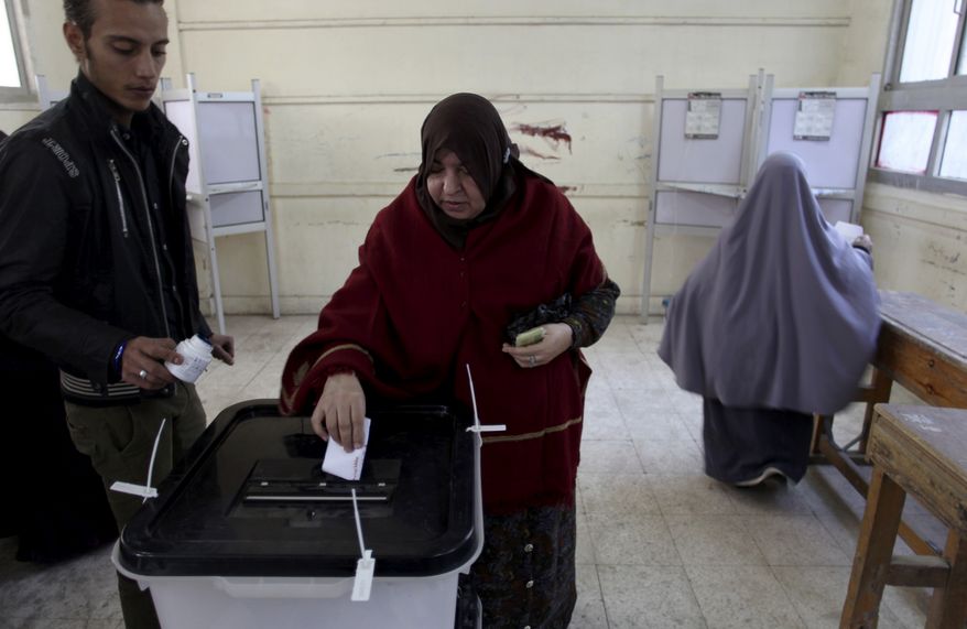 An Egyptian woman casts her vote in Cairo on Saturday, Dec. 15, 2012, during a referendum on a disputed constitution drafted by Islamist supporters of President Mohammed Morsi. (AP Photo/Khalil Hamra)