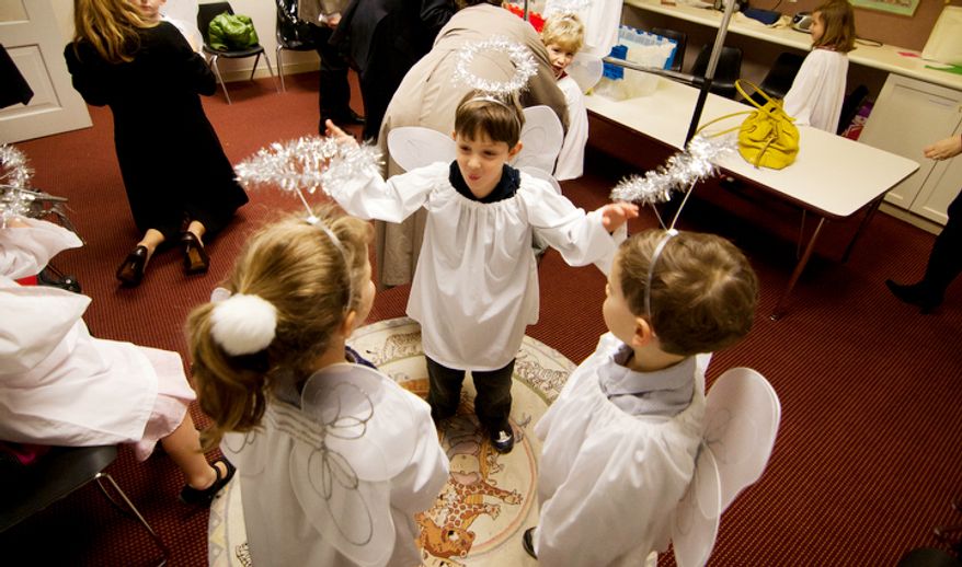 Children part of the Christ Church Sunday school and youth group dress up as angels and rehearse their song before their Christmas Pageant in Alexandria, Va., on Sunday, December 16, 2012. Christ Church was frequented by such notables as George Washington, Robert E. Lee, and Philip Richard Fendall I. The pageant is an annual event that has been taking place for over five decades. Children as young as kindergarden an as old as high schools take part in working, singing and acting in the pageant. (Craig Bisacre/The Washington Times)