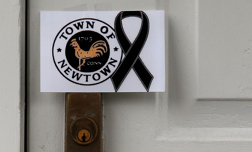 ** FILE ** A sign showing the town seal and a black ribbon is posted on the door of an antique colonial home in the historic district near the funeral for 6-year-old student and shooting victim Jack Pinto in Newtown, Conn., Monday, Dec. 17, 2012. A gunman opened fire at Sandy Hook Elementary School in the town, killing 26 people, including 20 children before killing himself on Friday. (AP Photo/Charles Krupa)