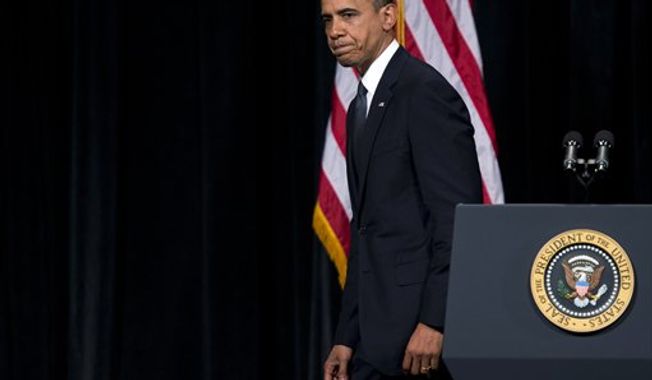 ** FILE ** President Obama walks off stage after delivering a speech at an interfaith vigil for the victims of the Sandy Hook Elementary School shooting on Sunday, Dec. 16, 2012, at Newtown High School in Newtown, Conn. (AP Photo/Evan Vucci)