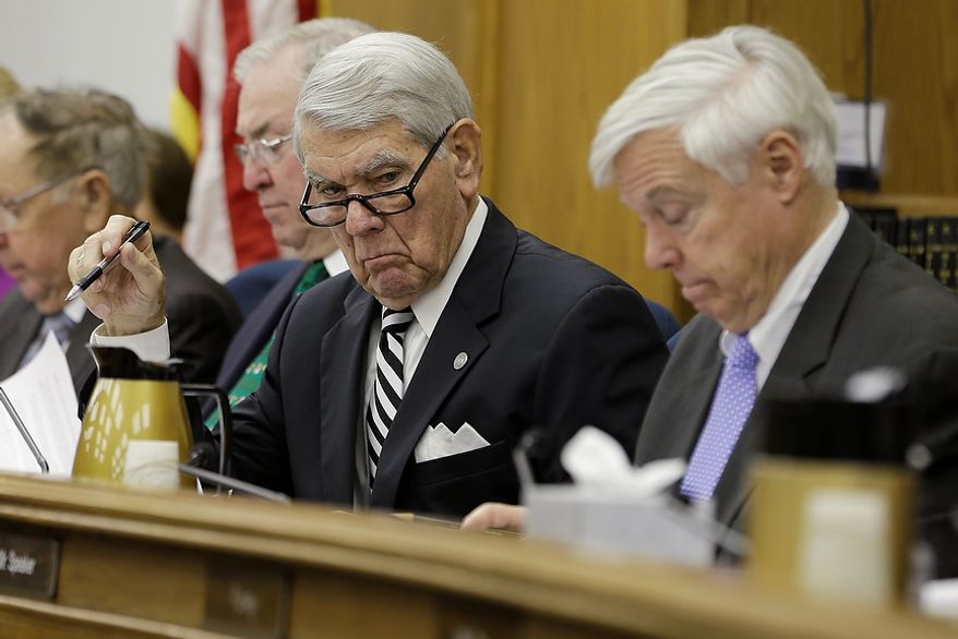Delegate Lacey Putney, the House Appropriations Committee chairman, and Delegate William Howell (right), the House speaker, listen as Virginia Gov. Bob McDonnell addresses a joint meeting of the House Appropriations and Senate Finance committees at the Capitol on Monday, Dec. 17, 2012, in Richmond. The governor delivered his 2013 budget proposals to the committees. (AP Photo/Steve Helber)