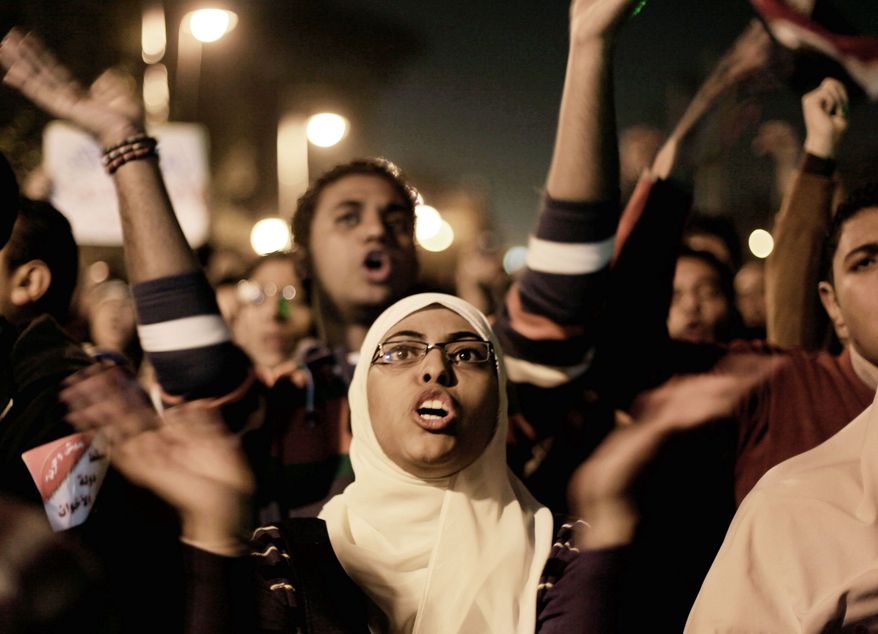 Egyptians opposing President Mohammed Morsi chant in Tahrir Square, Cairo, on Tuesday. Early results from the first round of voting on a draft constitution showed 56 percent in favor. The opposition fears that a large Islamist constituency in rural and upper Egypt will back it in the second round. (Associated Press)