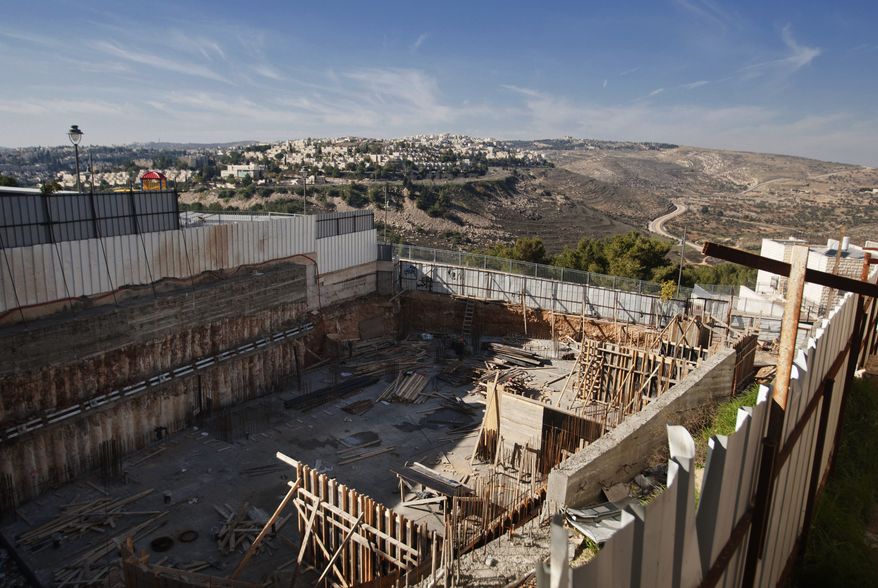 ** FILE ** Construction is underway at a site in the east Jerusalem neighborhood of Ramat Sholmo on Tuesday, Dec. 18, 2012. (Associated Press)