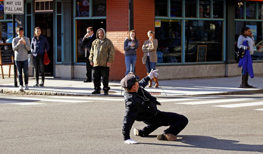 ** FILE ** Reserve Officer Tony Lepore, the "dancing cop," directs traffic on Dorrance Street in downtown Providence, R.I., on Thursday, Dec. 13, 2012. (AP Photo/Stephan Savoia)