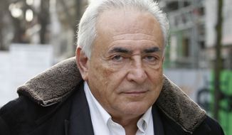 ** FILE ** Dominique Strauss-Kahn, former managing director of the International Monetary Fund, leaves his apartment building in Paris on Tuesday, Dec. 11, 2012. (AP Photo/Jacques Brinon)