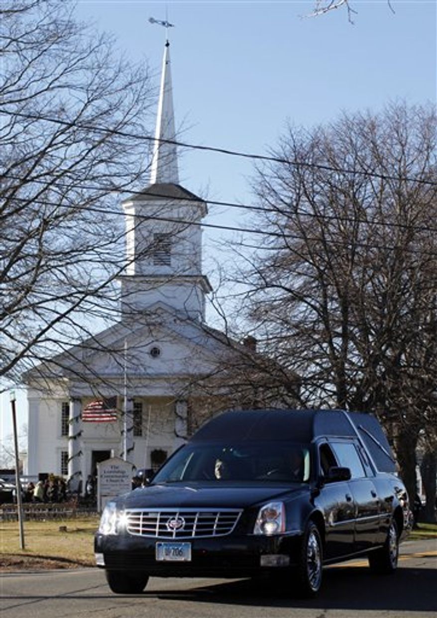 A hearse bearing the body of Victoria Soto drives past Lordship Community Church as it leaves after her funeral service, Wednesday, Dec. 19, 2012, in Stratford, Conn. Soto was killed when Adam Lanza walked into Sandy Hook Elementary School in Newtown, Conn., Dec. 14, and opened fire, killing 26 people, including 20 children, before killing himself. (AP Photo/Jason DeCrow)
