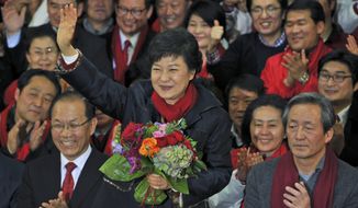 South Korean President-elect Park Geun-hye of the ruling Saenuri Party waves to supporters after arriving at party headquarters in Seoul on Wednesday, Dec. 19, 2012. (AP Photo/Kim Jae-hwan, Pool)