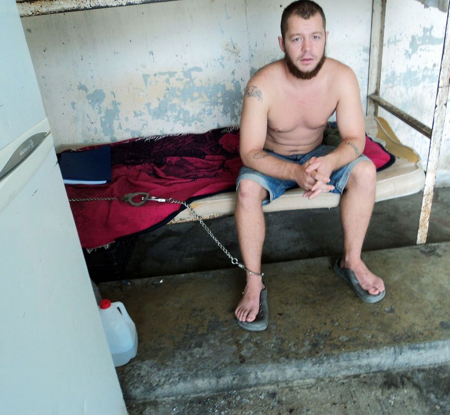 Former Marine Jon Hammar is shackled to his bunk in a prison in Matamoros, Mexico. The Iraq and Afghanistan combat veteran (official 2003 portrait at top) was arrested at the border while trying to declare a prized heirloom gun (below) he was carrying on a surfing trip. He reportedly is no longer in chains. (Associated Press)