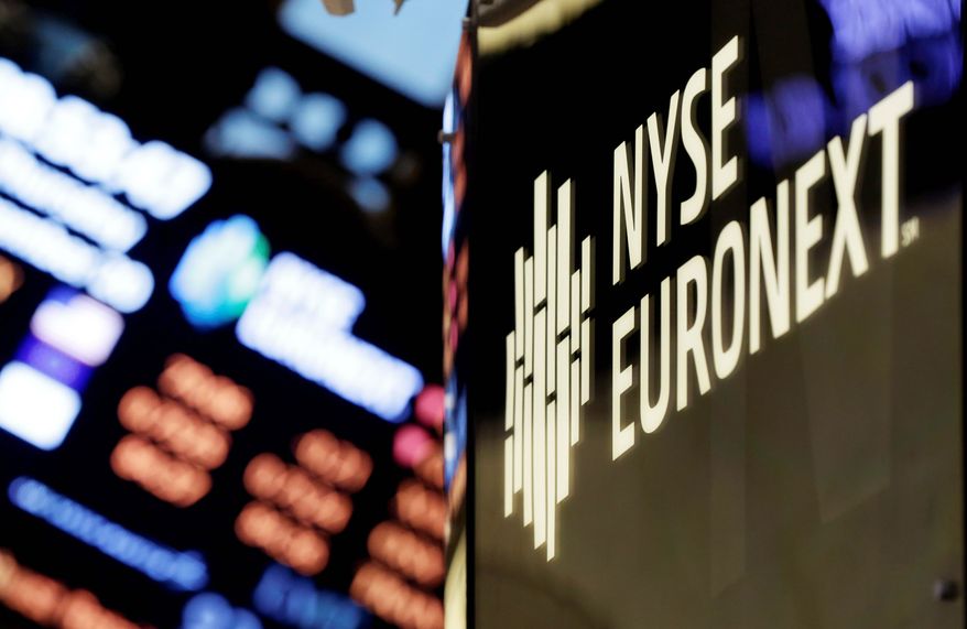 The corporate logo of the New York Stock Exchange is a familiar sight on the trading floor of the Big Apple landmark. The NYSE is being sold to a rival exchange for about $8 billion, ending more than two centuries of independence for the iconic Big Board. The buyer said Thursday that little would change on the trading floor. (Associated Press)