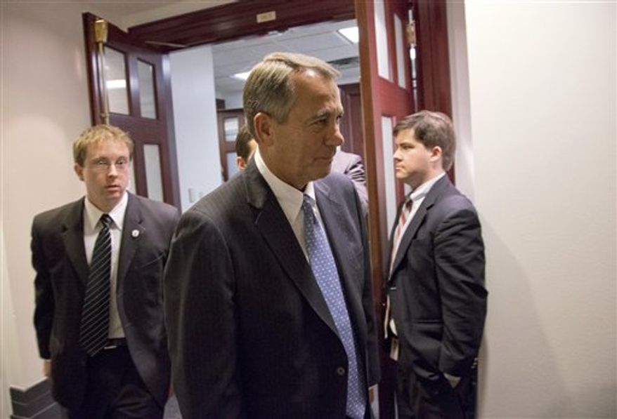 Speaker John A. Boehner of Ohio, center, departs after a House Republicans meeting on Capitol Hill, Thursday, Dec. 20, 2012. Confronted with a revolt among the rank and file, House Republicans abruptly put off a vote Thursday night on legislation allowing tax rates to rise for households earning $1 million and up. (AP Photo/Alex Brandon)