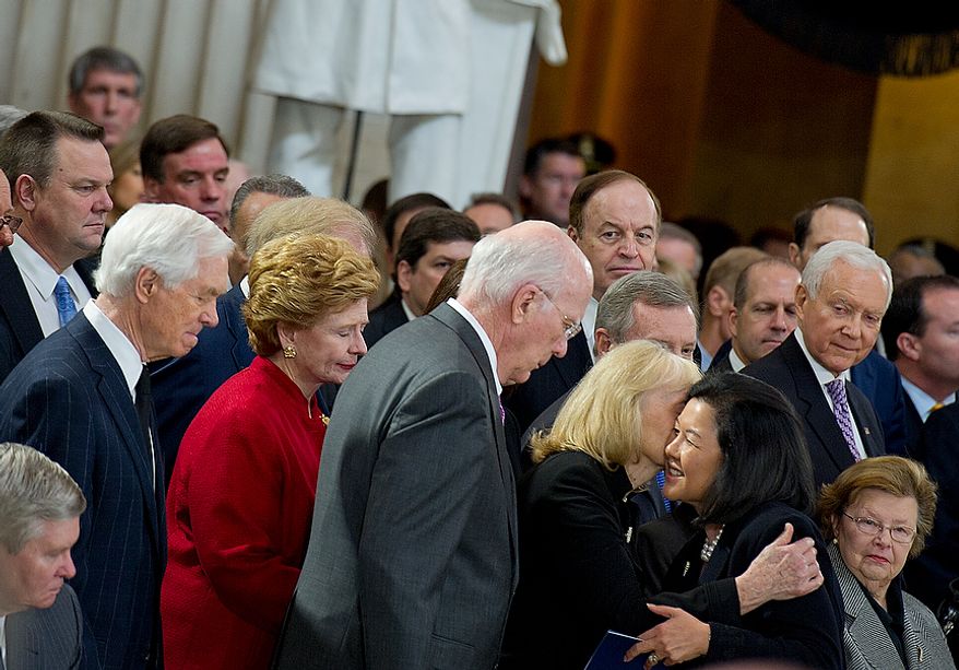 Irene Hirano Inouye, the widow of the late Sen. Daniel Inouye, embraces other U.S. senators following a memorial service at the U.S. Capitol rotunda on Thursday, Dec. 20, 2012. Sen. Inouye, who served as a U.S. senator for 50 years, is only the 31st person to lie in state in the rotunda of the U.S. Capitol. It is seen as a sign of respect. (Barbara L. Salisbury/The Washington Times)