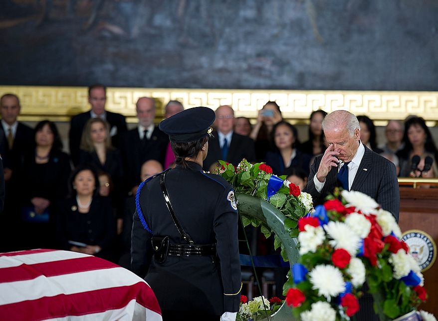 Vice Pres. Joe Biden crosses himself after laying a wreath during a memorial service for the late Sen. Daniel Inouye on at the U.S. Capitol rotunda on Thursday, Dec. 20, 2012. The vice president, who served with Inouye in the Senate and was very close with him, delivered the eulogy. (Barbara L. Salisbury/The Washington Times)