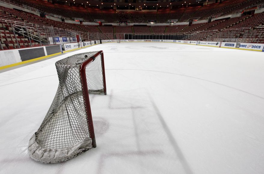 In this photo taken Tuesday, Dec. 18, 2012, a hockey goal sits on the ice at Joe Louis Arena home of the Detroit Red Wings hockey club in Detroit. The NHL lockout that's already wiped out the first three months of the season is taking its toll on small businesses in many of the NHL's markets. (AP Photo/Paul Sancya, File)