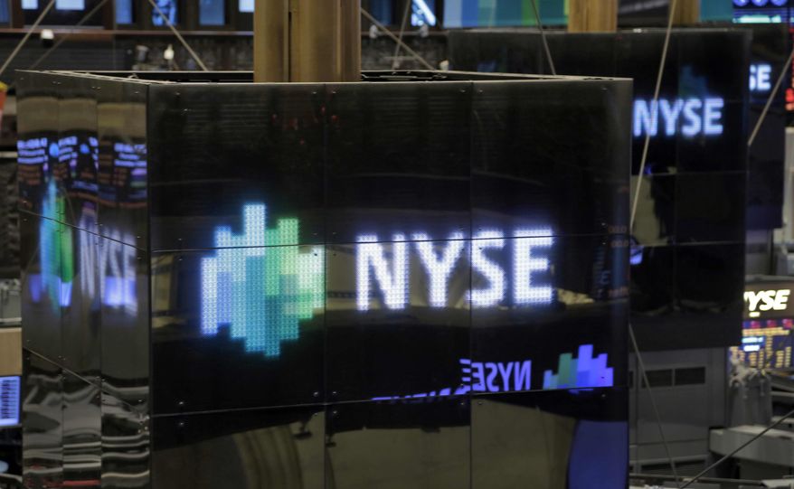 NYSE logos top trading posts on the floor of the New York Stock Exchange Thursday, Dec. 20, 2012. (AP Photo/Richard Drew)