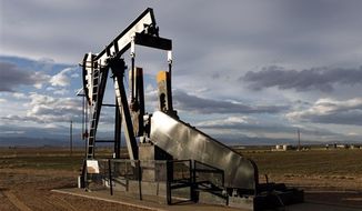 ** FILE ** This Dec. 5, 2012, photo shows an oil pump jack in a field adjacent to a sub-division near Fredrick, Colo. Citizen fears about hydraulic fracturing, a drilling procedure used to pry oil and gas from rock deep underground, have made &quot;fracking&quot; the hottest political question in Colorado.