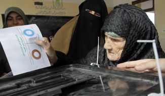 Amnah Sayyed Moussa, 85, casts her vote in the second round of a referendum on a disputed constitution drafted by Islamist supporters of Egyptian President Mohammed Morsi in Giza, Egypt, on Saturday, Dec. 22, 2012. (AP Photo/Amr Nabil)