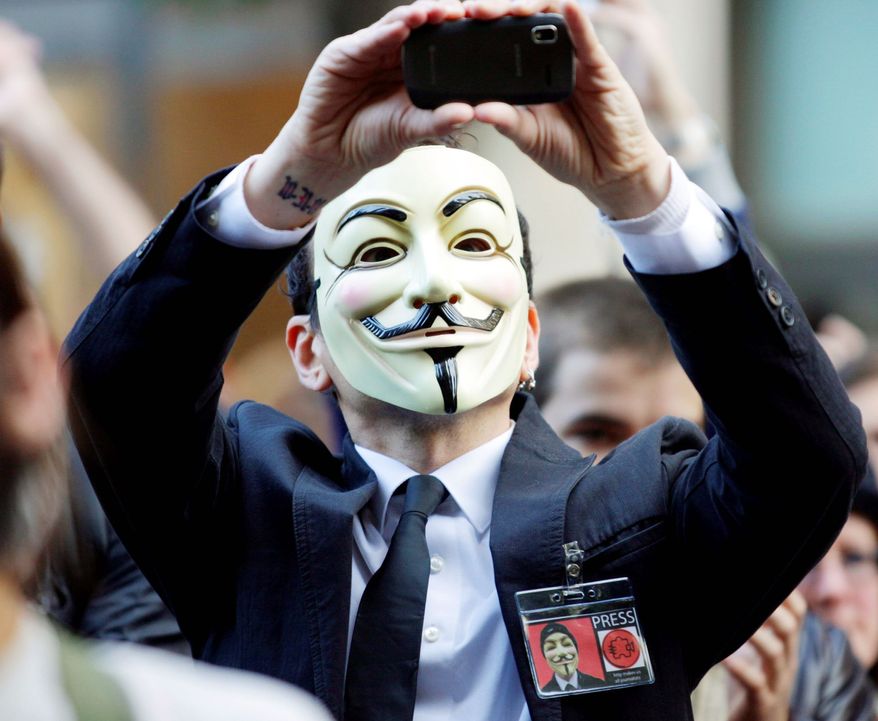 An "Occupy Seattle" protester wears a Guy Fawkes mask while demonstrating in October 2011. Guy Fawkes masks are featured prominently in "V for Vendetta," which was telecast Friday in China. (Associated Press)