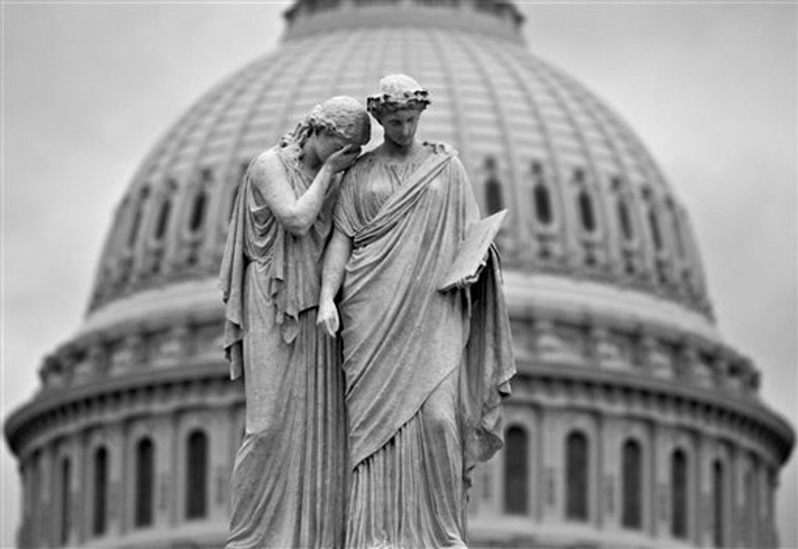Gray skies cover the U.S. Capitol in Washington as Congress closes down for the holiday without a compromise on the "fiscal cliff" threatening the U.S. economy, in Washington, Friday, Dec. 21, 2012. Hopes for avoiding the "fiscal cliff" fell Friday after fighting among congressional Republicans cast doubt on whether any deal reached with President Obama could win approval ahead of automatic tax increases and deep spending cuts kick in Jan. 1. (AP Photo/J. Scott Applewhite)